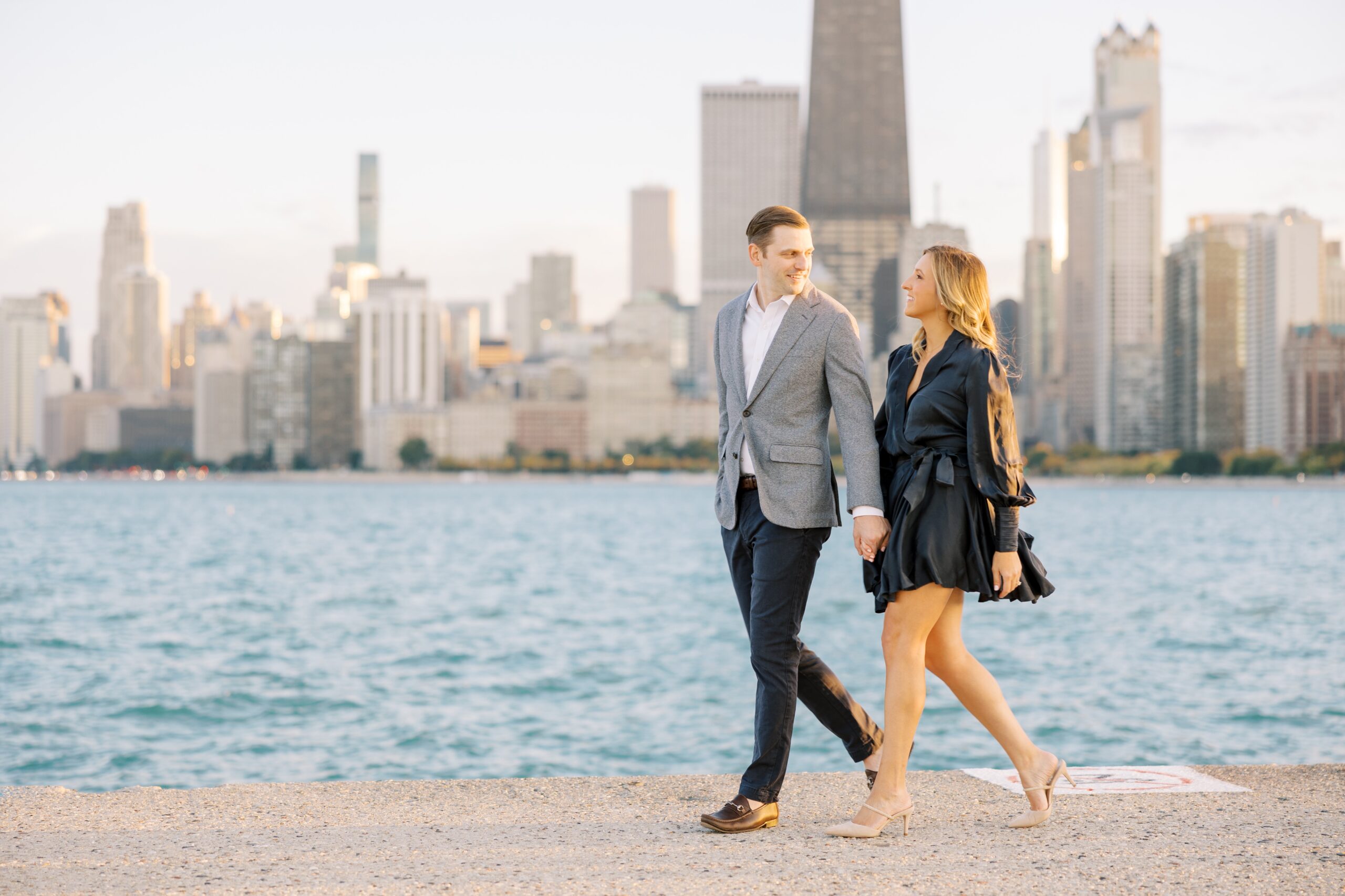 Couple walks during fall North Avenue Beach engagement photos