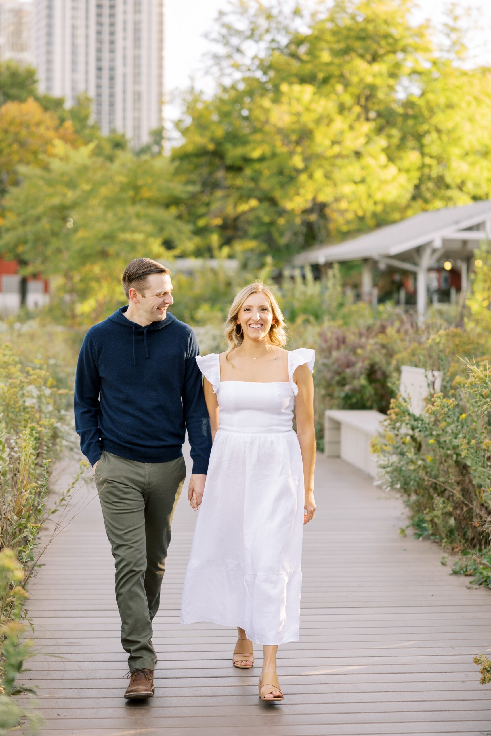 Couple walks around Lincoln Park Zoo during fall engagement photos