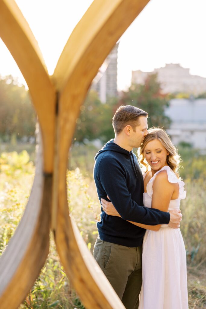 Man and woman hug during fall engagement photos in Chicago