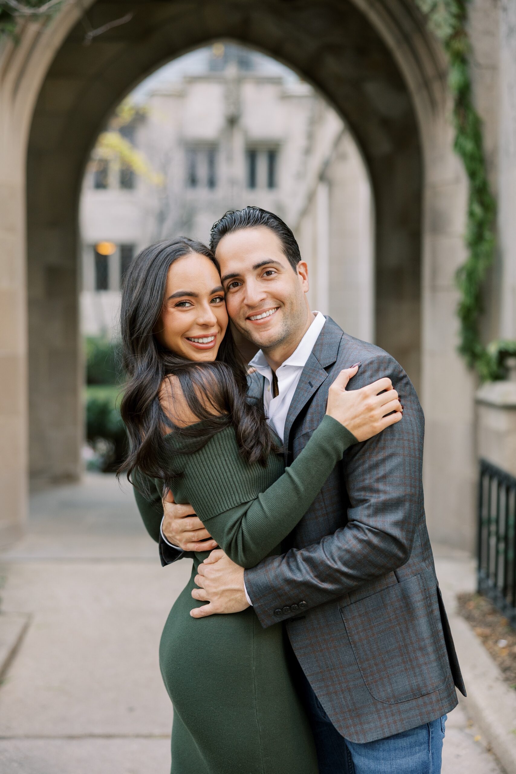 Man and woman hug and smile at the camera during engagement photos at Fourth Presbyterian Church Chicago