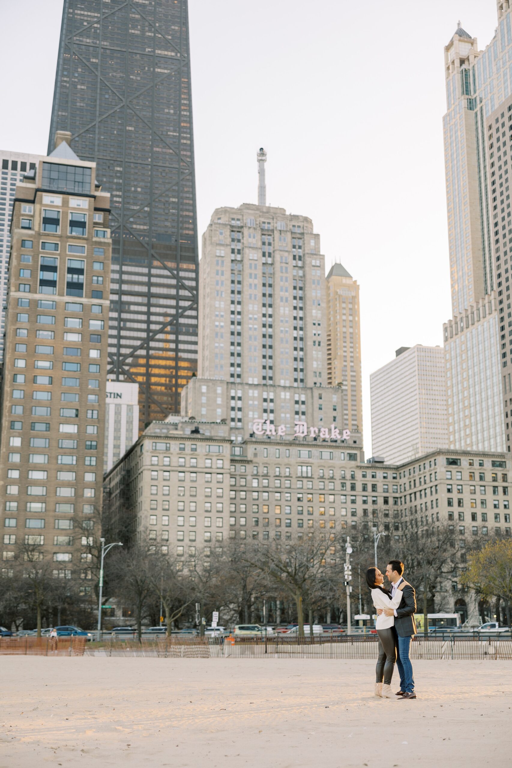 Man and woman hug with Chicago skyline backdrop
