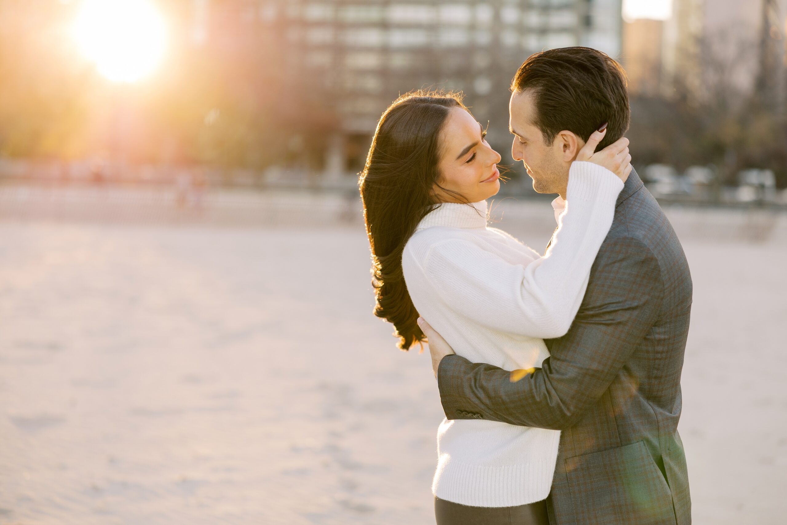Man and woman embrace during Chicago engagement photos