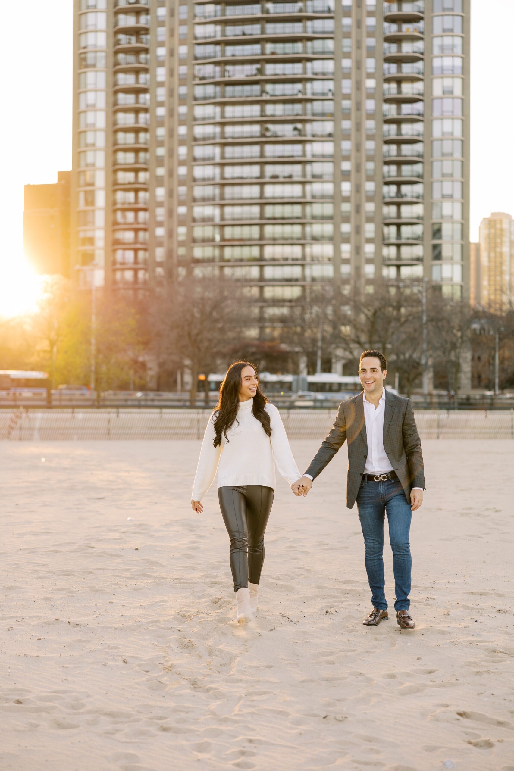 Man and woman hold hands at the Chicago engagement photo session