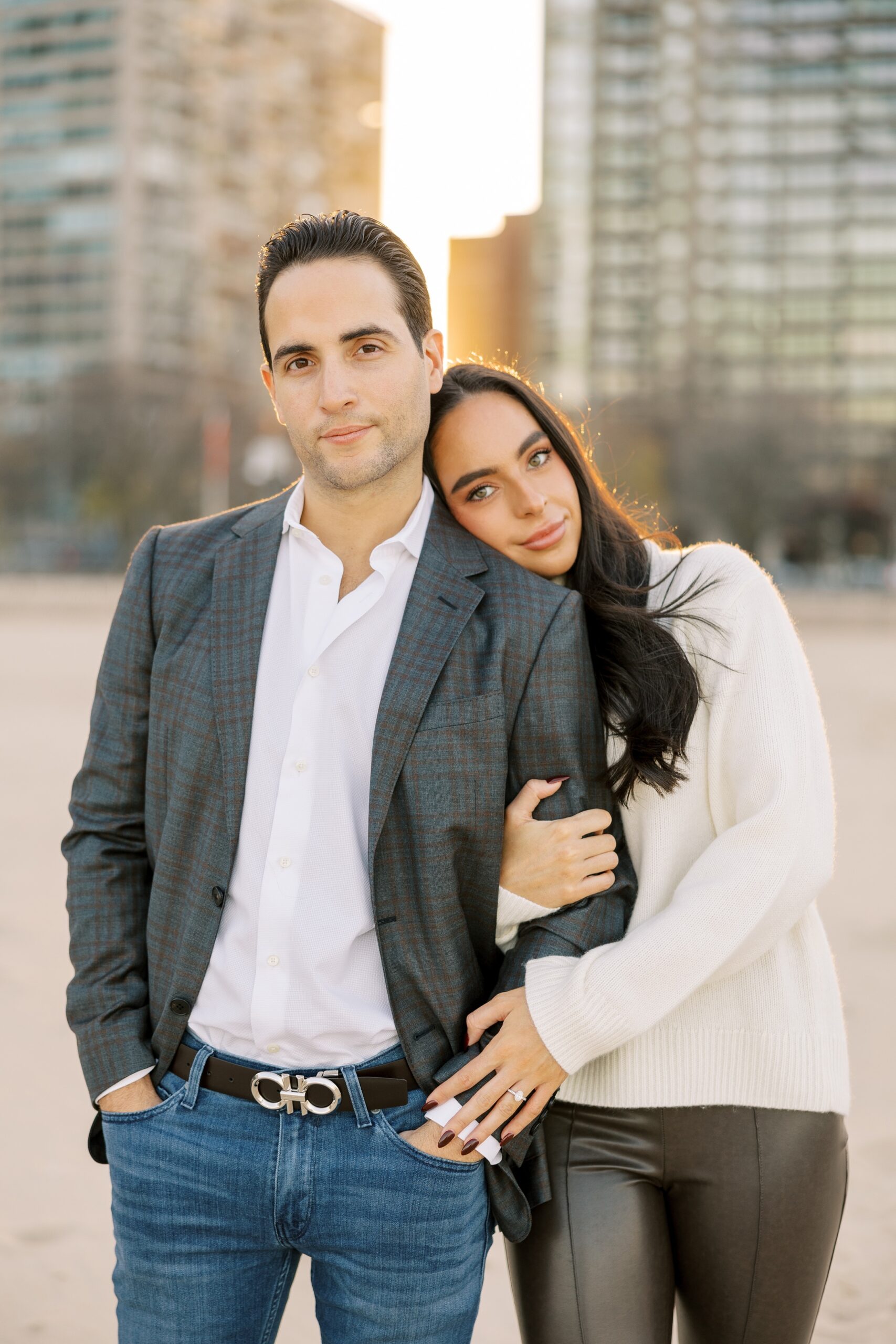 Man and woman soft smile at the camera during Chicago engagement photos