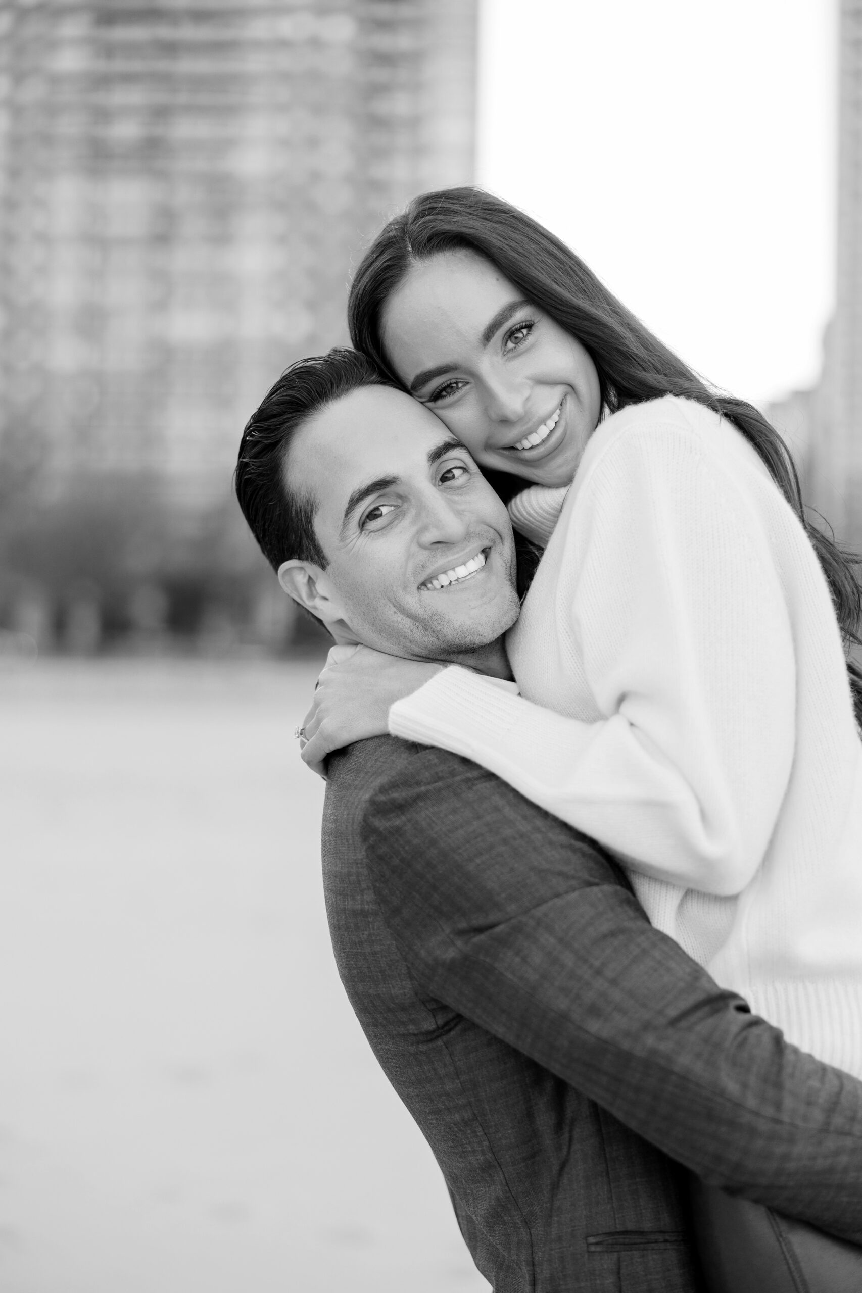 Man and woman hug during engagement photos in Chicago