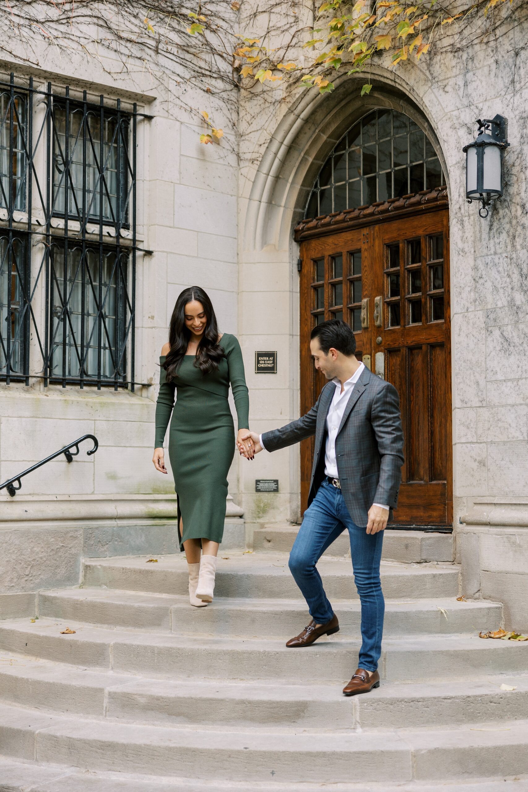 Man and woman hold hands walking down stairs at Fourth Presbyterian Church Chicago