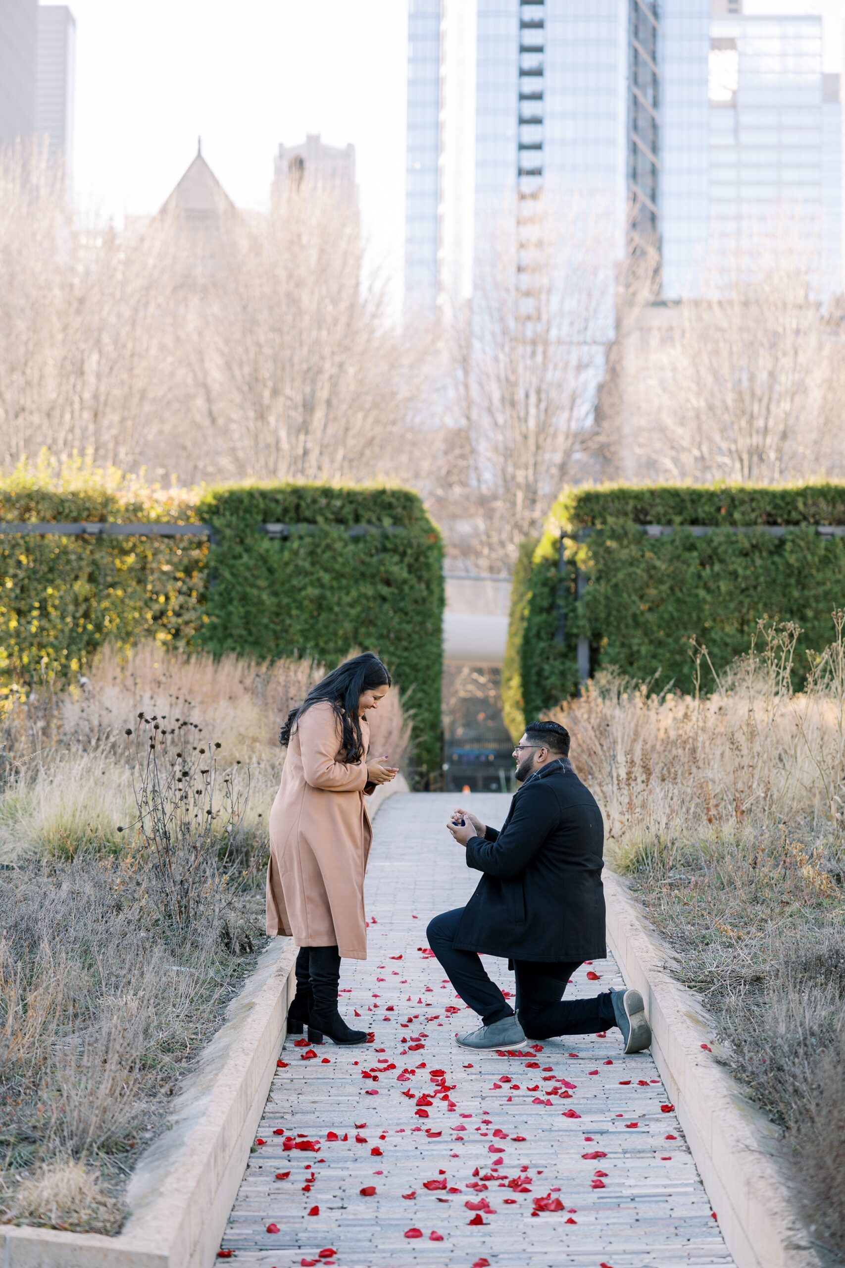 Excited woman being proposed to in a garden