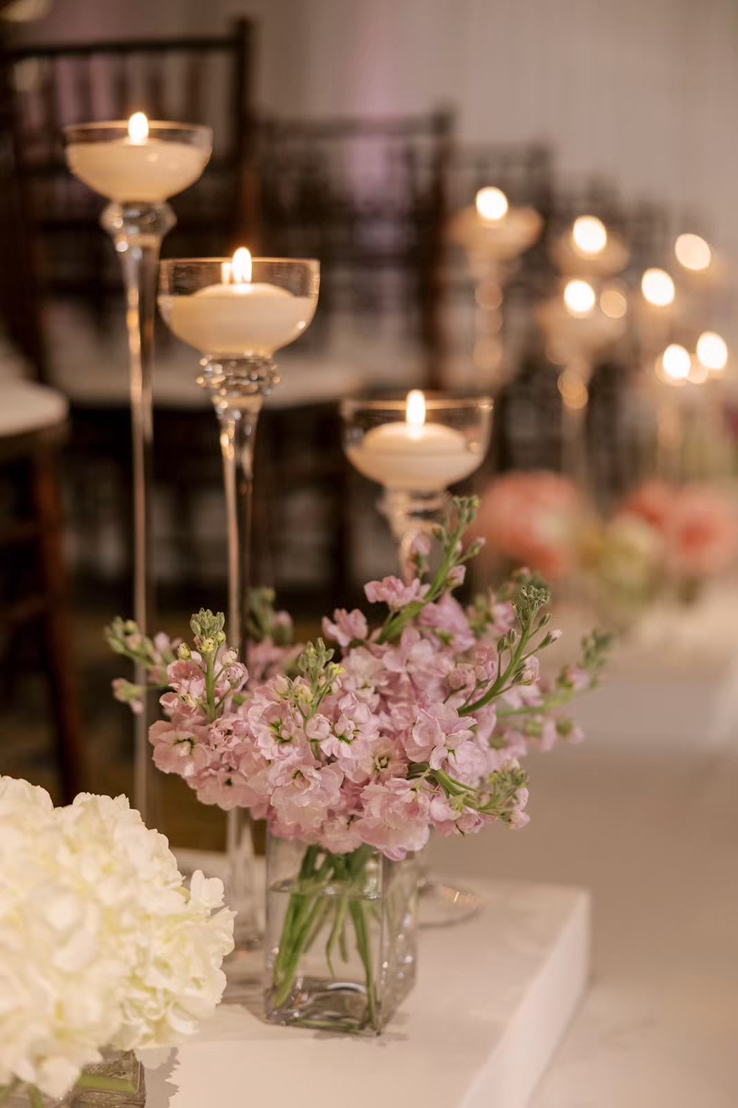 Candles and flowers adorning the aisle of the Peninsula Chicago wedding ceremony