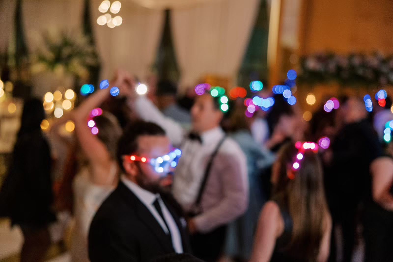 Guests dancing with glow sticks at the Peninsula Chicago wedding reception