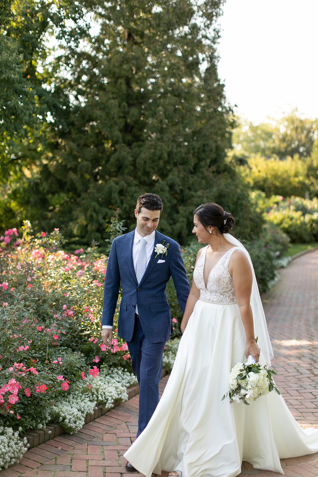 bride and groom walking in the Rose Garden at the Chicago Botanic Garden
