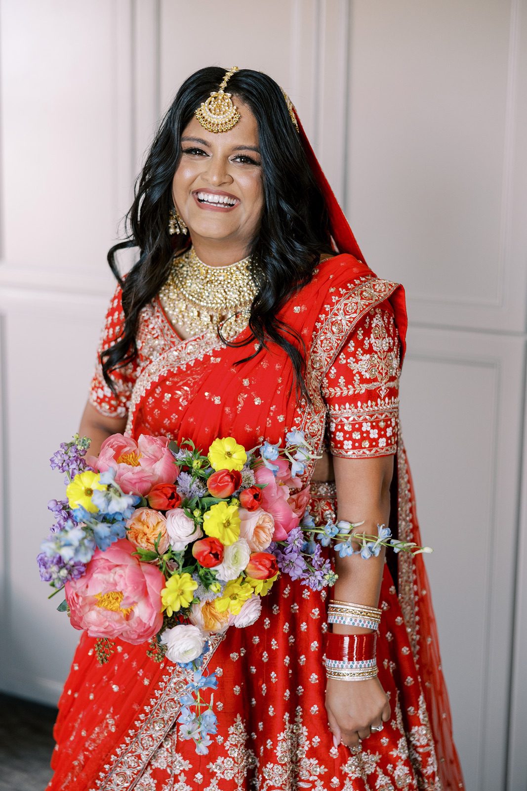 Bride in red lehenga before the Venue SIX10 wedding ceremony and reception