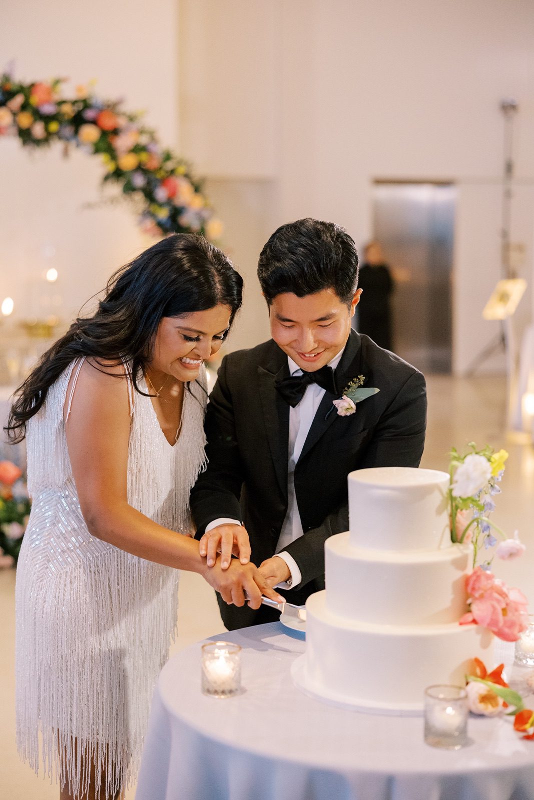 Bride and groom cut their wedding cake at their Venue SIX10 wedding