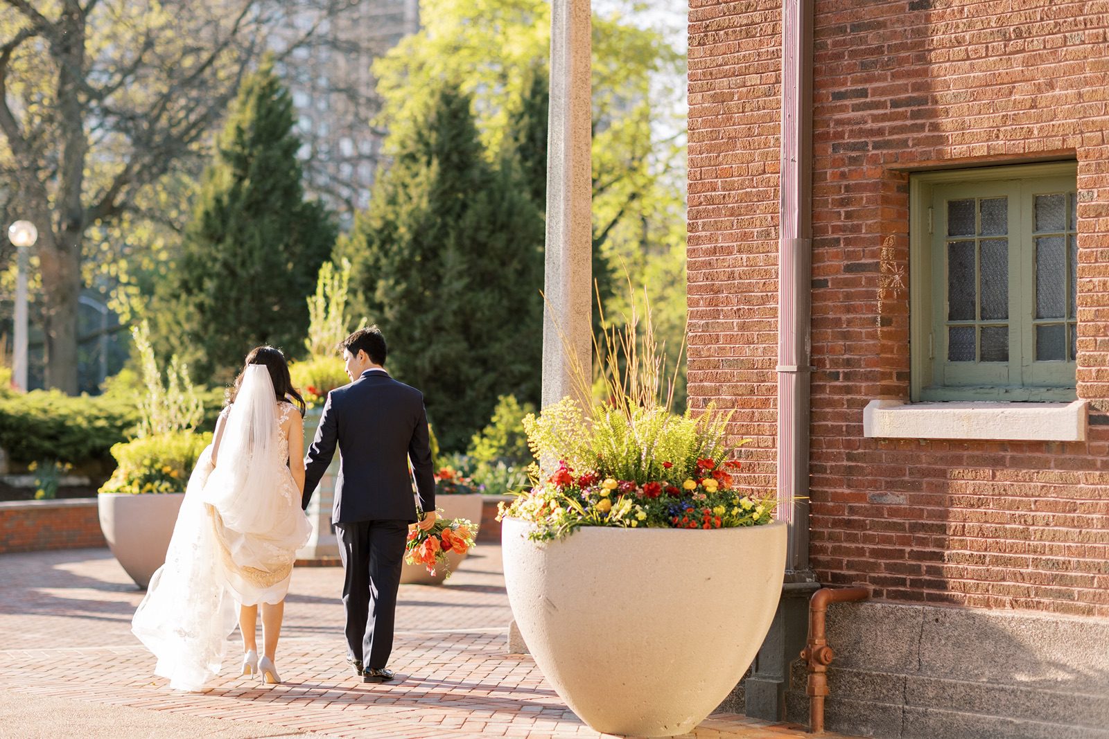 Bride and groom explore the Lincoln Park Zoo at their Cafe Brauer wedding