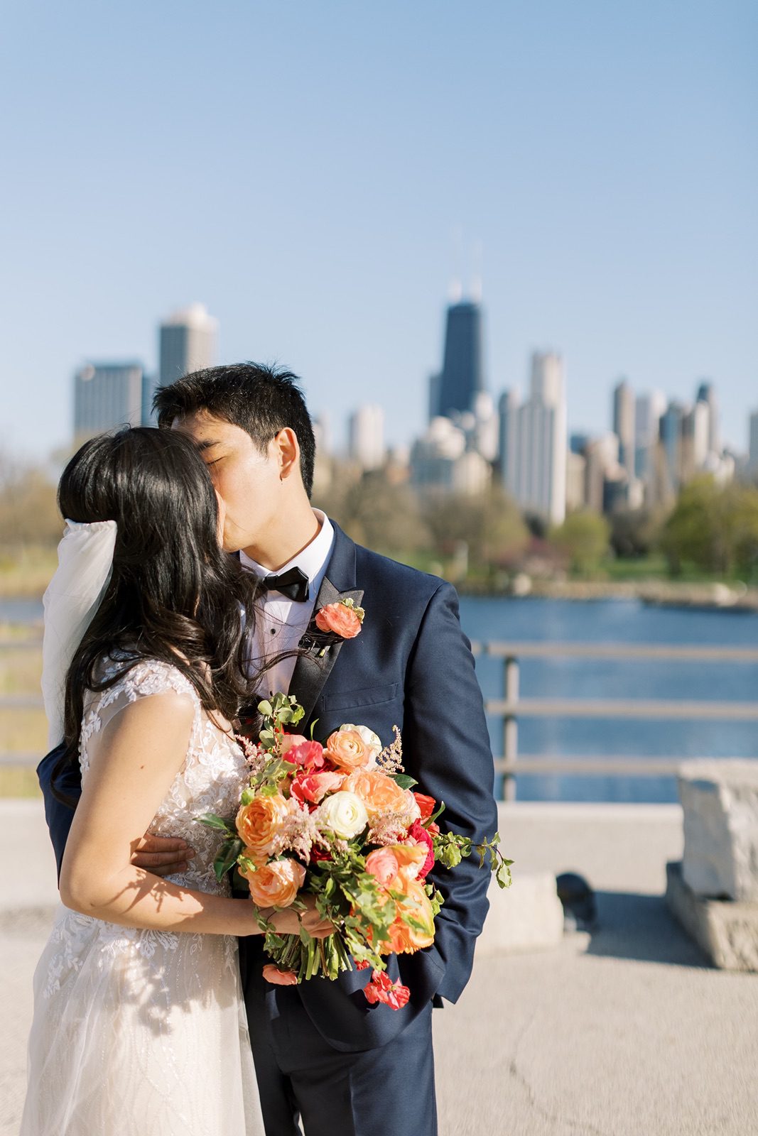 Bride and groom kiss with the Chicago skyline