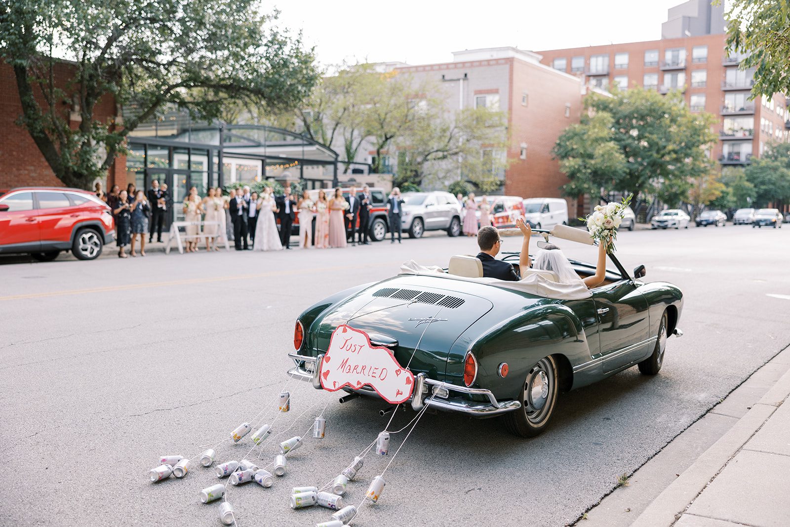 Bride and groom leave Galleria Marchetti in vintage getaway car