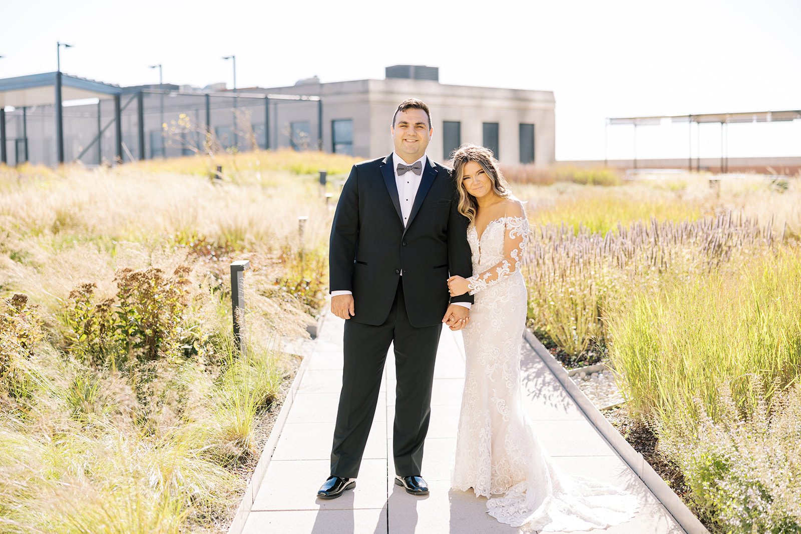 Bride and groom smile on the rooftop of the Old Post Office in Chicago