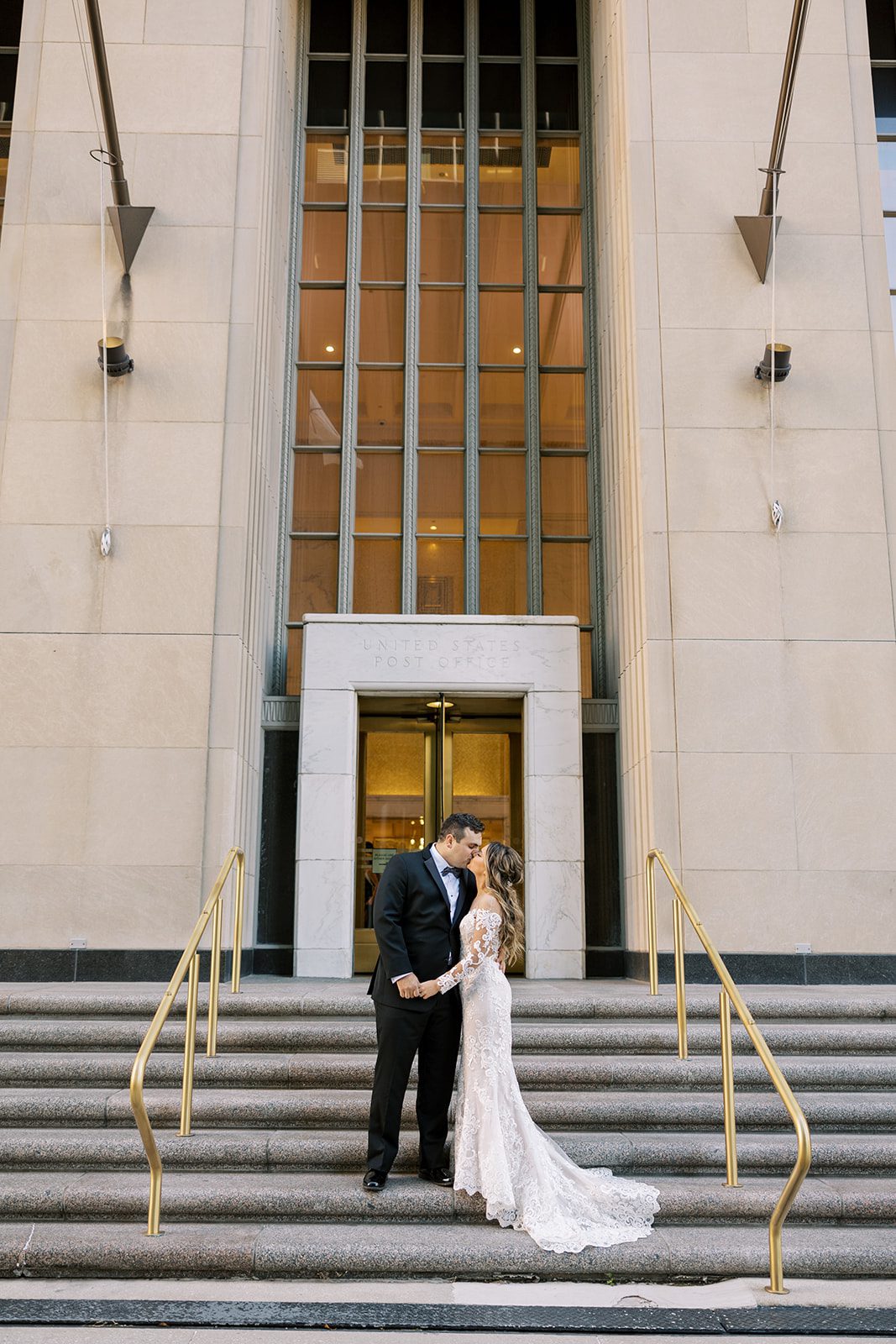 The bride and groom kissed outside of The Old Post Office